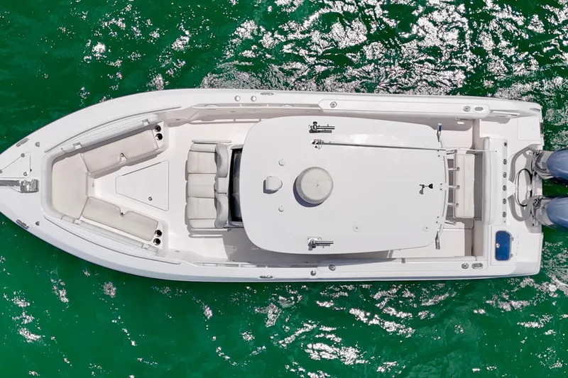 Slide: The Image of Overhead view of 2015 Everglades 295 Center Console boat on sparkling green water. - 3