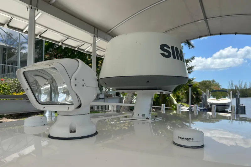 Slide: The Image of Radar and spotlight on 2015 Everglades 295 Center Console boat under canopy. - 37