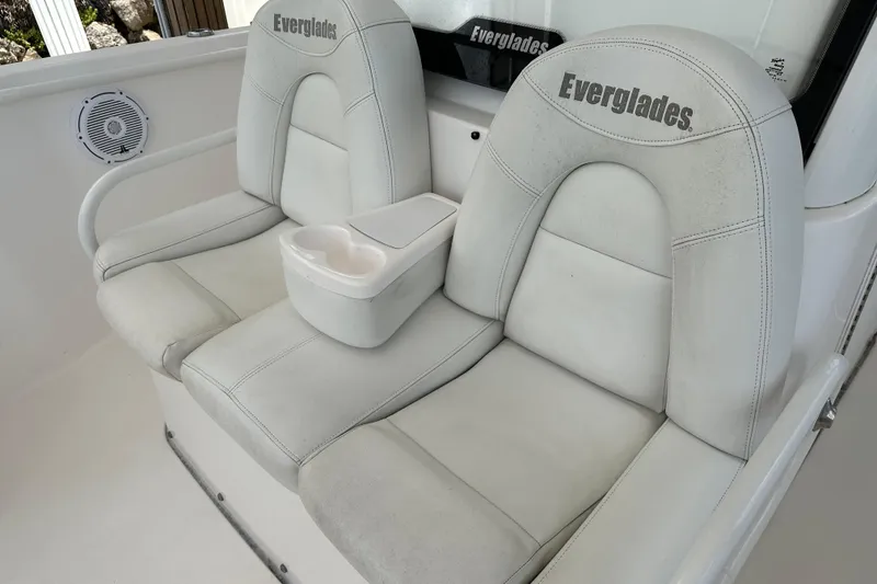Slide: The Image of 2015 Everglades 295 Center Console boat seats with cup holder, white upholstery. - 40