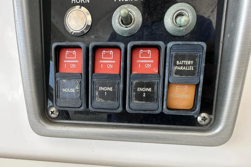 Slide: The Image of Control panel of a 2015 Everglades 295 Center Console boat with battery switches. - 49