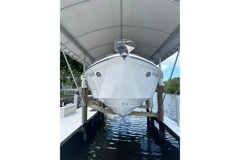 Slide: The Image of 2015 Everglades 295 Center Console boat docked under a canopy. - 51