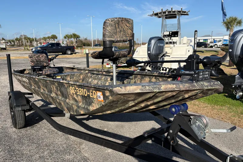 Slide: The Image of 2022 Crestliner 1546 Retriever boat with camouflage design on a trailer. - 11