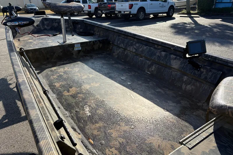 Slide: The Image of 2022 Crestliner 1546 Retriever boat with camouflage interior, parked outdoors. - 15