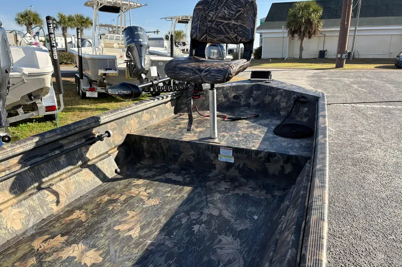 Slide: The Image of 2022 Crestliner 1546 Retriever boat with camo interior, parked outdoors. - 16