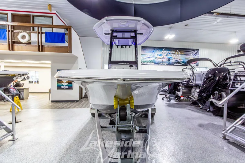 Slide: The Image of 2026 Tidewater 210 CC Adventure boat displayed in showroom at Lakeside Marina. - 10