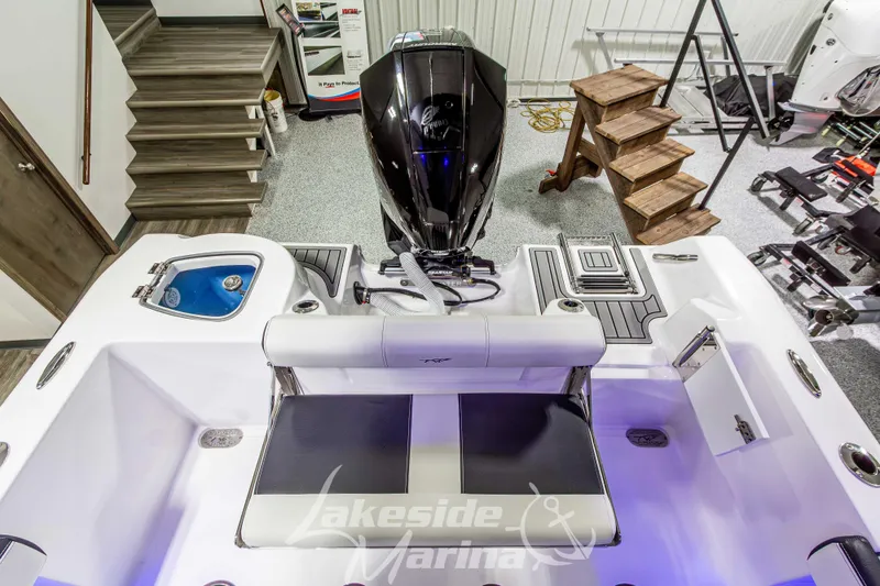 Slide: The Image of 2026 Tidewater 210 CC Adventure boat interior with motor, seating, and storage compartments. - 11