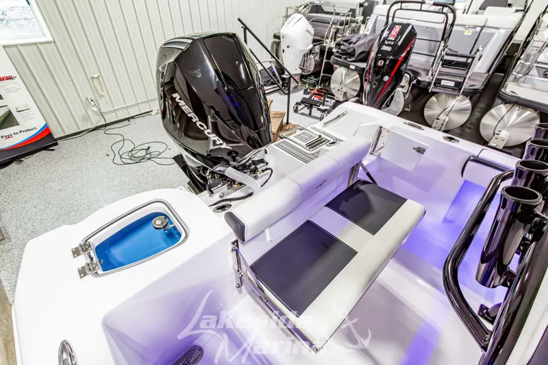 Slide: The Image of 2026 Tidewater 210 CC Adventure boat interior with Mercury engine in showroom. - 13