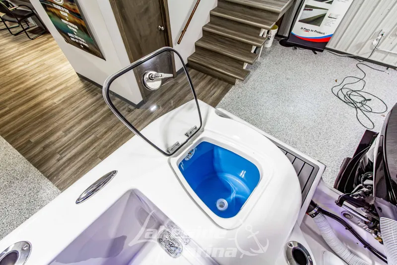 Slide: The Image of 2026 Tidewater 210 CC Adventure boat with open hatch and blue interior. - 14