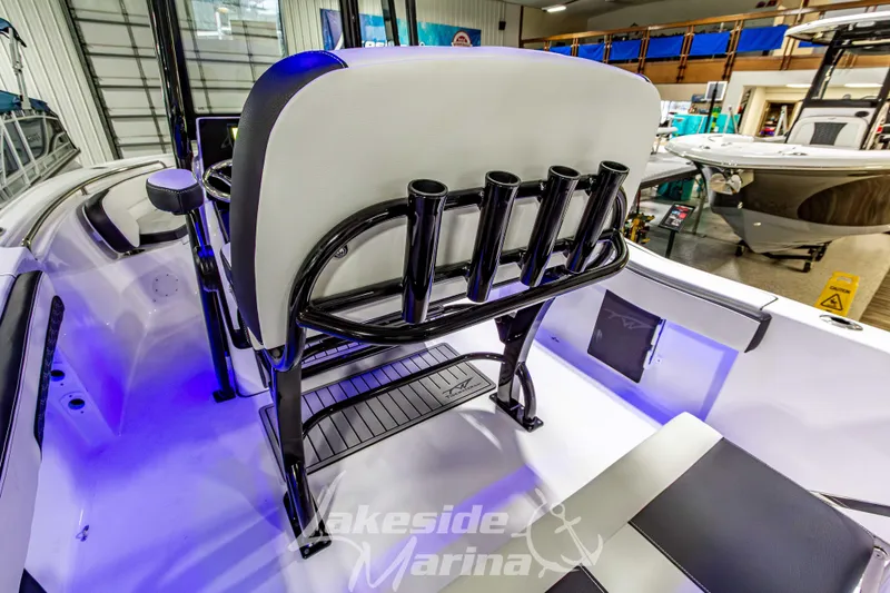 Slide: The Image of 2026 Tidewater 210 CC Adventure boat interior with rod holders and seating at Lakeside Marina. - 17