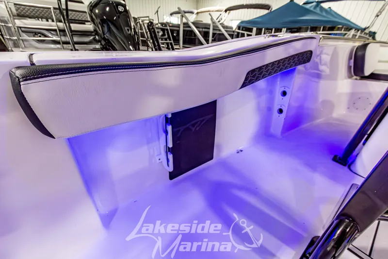 Slide: The Image of 2026 Tidewater 210 CC Adventure boat interior with blue LED lighting at Lakeside Marina. - 18