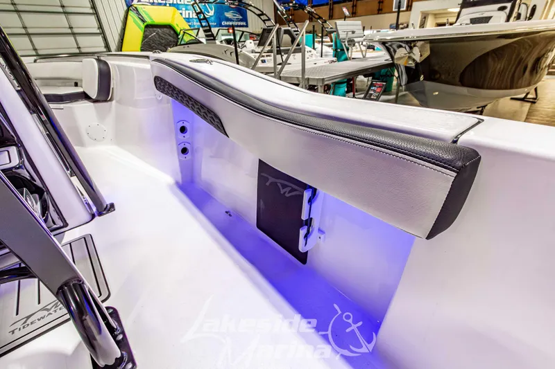 Slide: The Image of 2026 Tidewater 210 CC Adventure boat interior with blue LED lighting and sleek seating. - 19