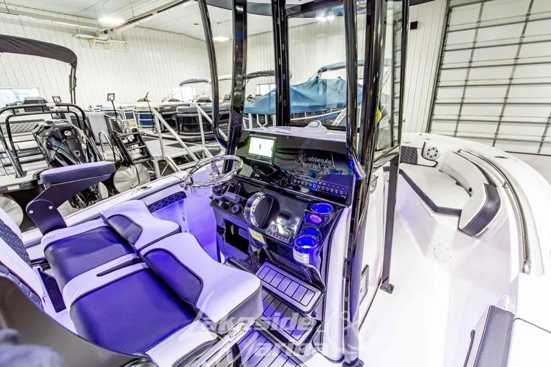 Slide: The Image of 2026 Tidewater 210 CC Adventure boat interior with modern console and seating. - 21