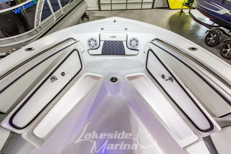 Slide: The Image of 2026 Tidewater 210 CC Adventure boat interior with storage compartments and speakers at Lakeside Marina. - 39