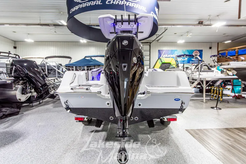 Slide: The Image of 2026 Tidewater 210 CC Adventure boat displayed in showroom with powerful outboard motor. - 5