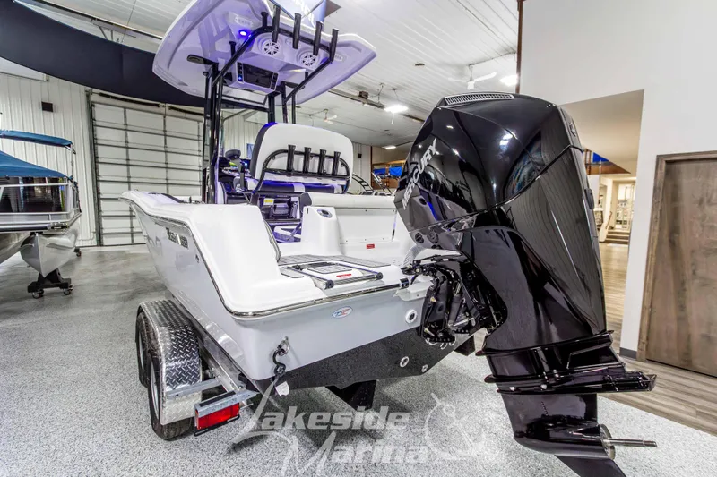 Slide: The Image of 2026 Tidewater 210 CC Adventure boat with Mercury outboard motor in showroom. - 6