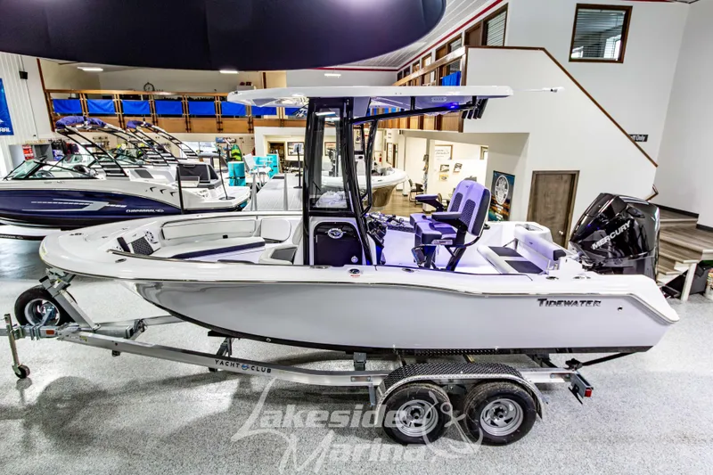 Slide: The Image of 2026 Tidewater 210 CC Adventure boat displayed indoors on a trailer. - 8