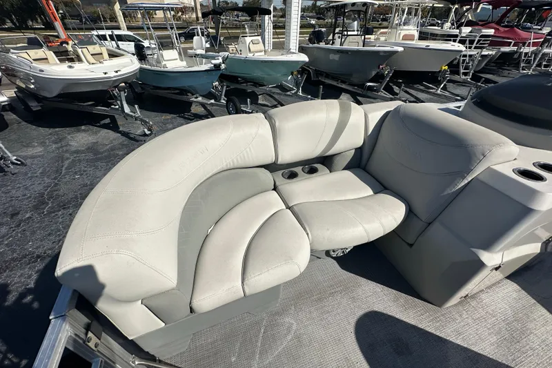 Slide: The Image of 2018 Sylvan Mirage Cruise 8520 boat interior with plush seating and cup holders. - 11