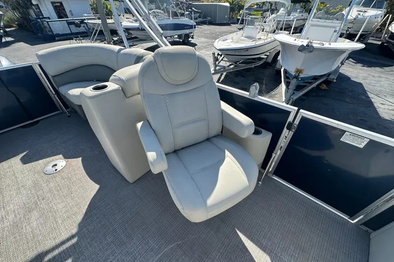 Slide: The Image of 2018 Sylvan Mirage Cruise 8520 boat interior with plush seating and cup holders. - 13