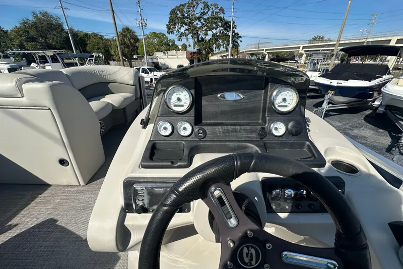 Slide: The Image of 2018 Sylvan Mirage Cruise 8520 boat dashboard with steering wheel and gauges. - 15