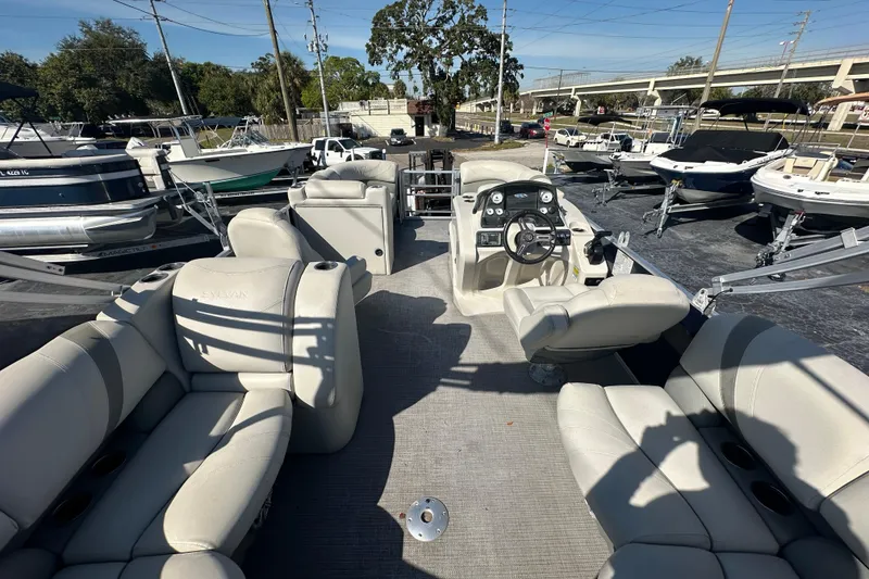 Slide: The Image of 2018 Sylvan Mirage Cruise 8520 pontoon boat interior with plush seating and steering console. - 19