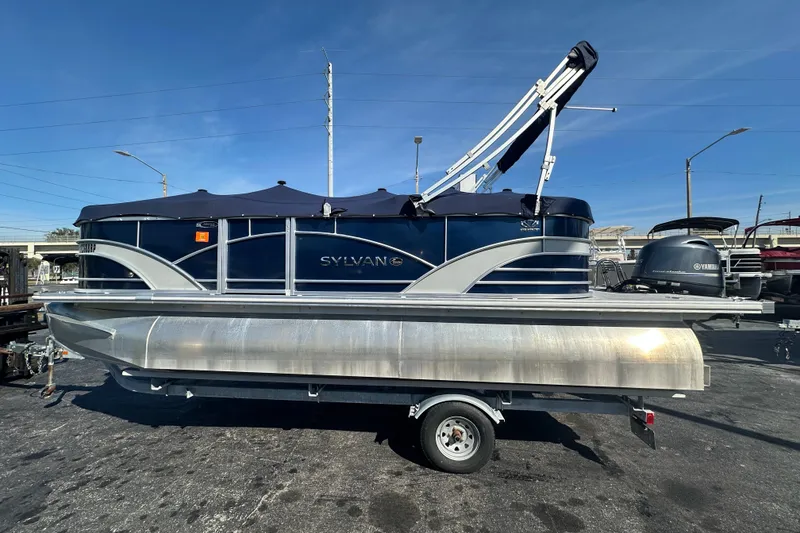 Slide: The Image of 2018 Sylvan Mirage Cruise 8520 pontoon boat on trailer, parked outdoors. - 2