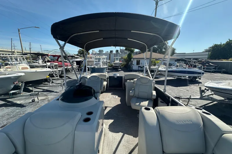 Slide: The Image of 2018 Sylvan Mirage Cruise 8520 pontoon boat with canopy, parked in a marina. - 20