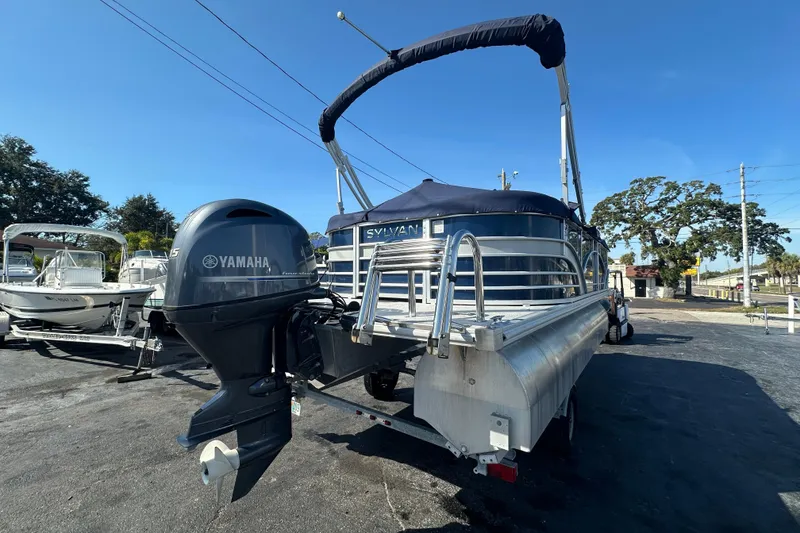 Slide: The Image of 2018 Sylvan Mirage Cruise 8520 pontoon boat with Yamaha outboard motor, parked outdoors. - 5