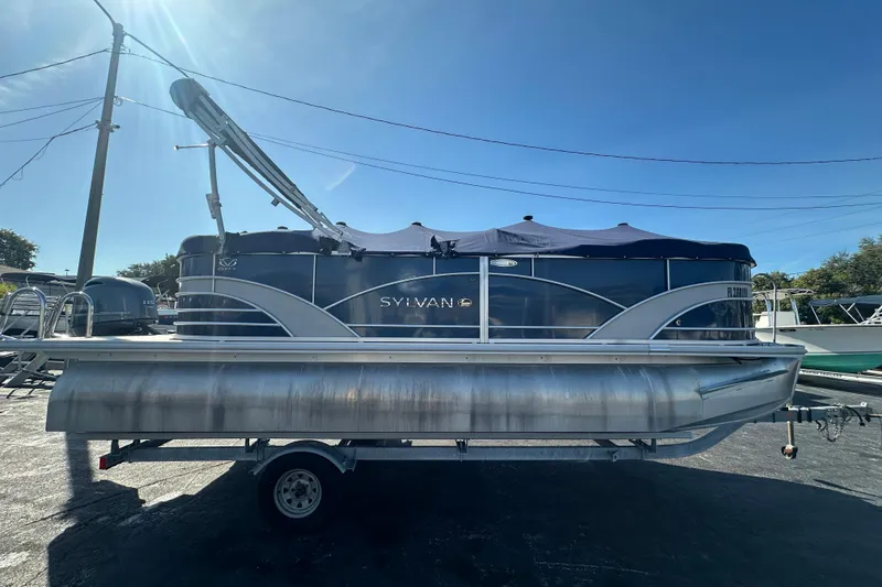 Slide: The Image of 2018 Sylvan Mirage Cruise 8520 pontoon boat on trailer under clear blue sky. - 7