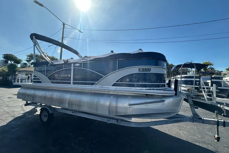 Slide: The Image of 2018 Sylvan Mirage Cruise 8520 pontoon boat on trailer under sunny sky. - 8