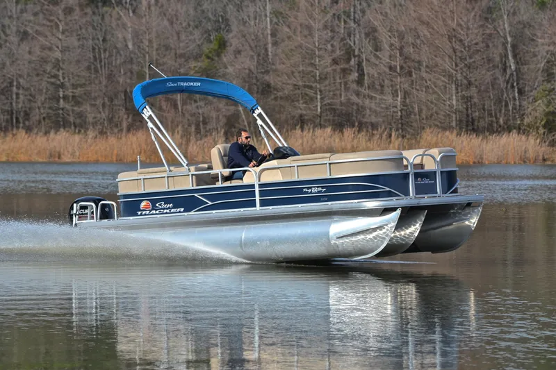 The Image of 2019 Sun Tracker Party Barge 22 XP3 cruising on a serene lake. - 1