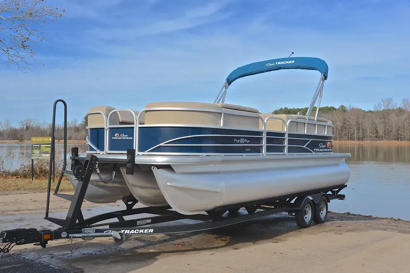 Slide: The Image of 2019 Sun Tracker Party Barge 22 XP3 pontoon boat on trailer by a lake. - 10