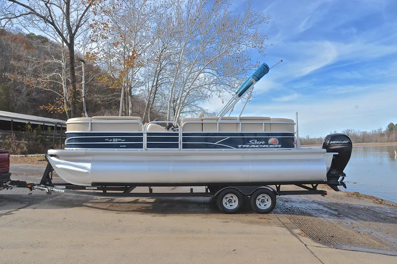 Slide: The Image of 2019 Sun Tracker Party Barge 22 XP3 pontoon boat on trailer by a lake. - 11