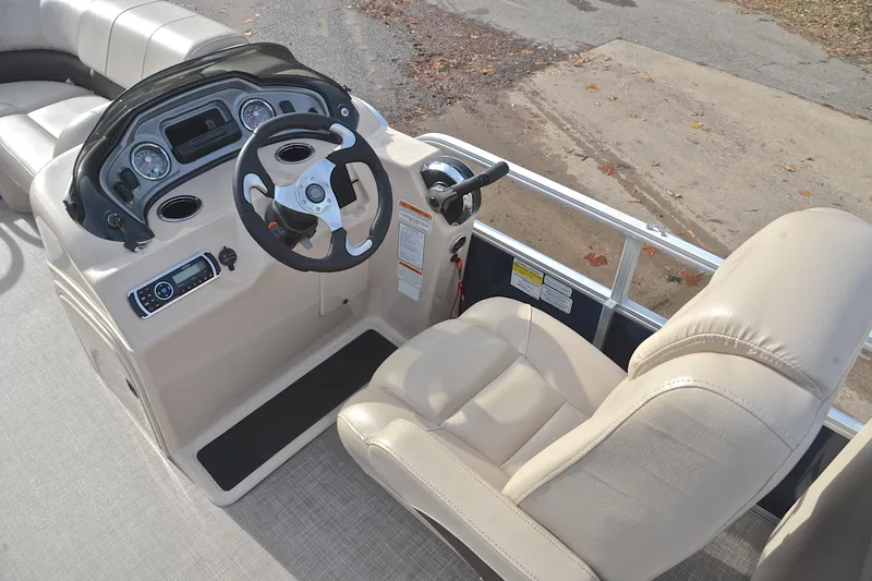 Slide: The Image of 2019 Sun Tracker Party Barge 22 XP3 helm with beige captain's chair and control panel. - 25