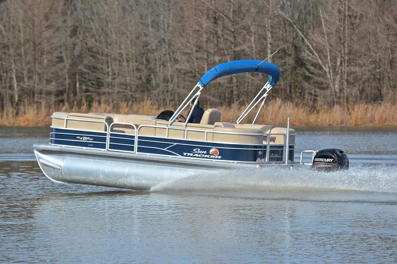 Slide: The Image of 2019 Sun Tracker Party Barge 22 XP3 pontoon boat cruising on a lake. - 4