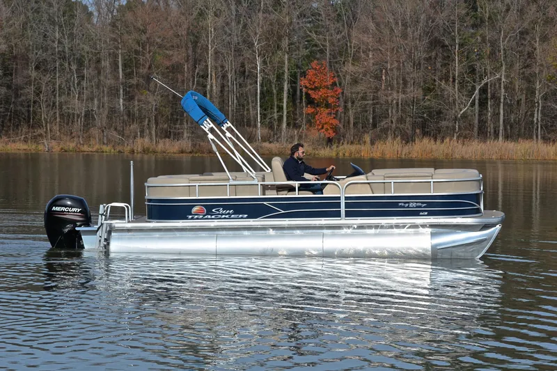 Slide: The Image of 2019 Sun Tracker Party Barge 22 XP3 pontoon boat cruising on a calm lake. - 6