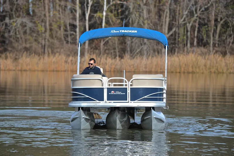Slide: The Image of 2019 Sun Tracker Party Barge 22 XP3 on a calm lake with trees in the background. - 9