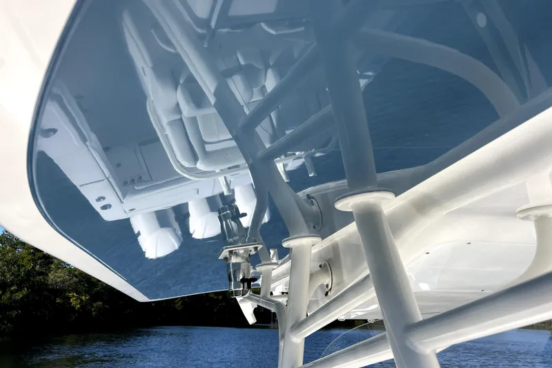 Slide: The Image of 2018 Regulator 34 Center Console boat reflecting on water, showcasing sleek design and structure. - 21