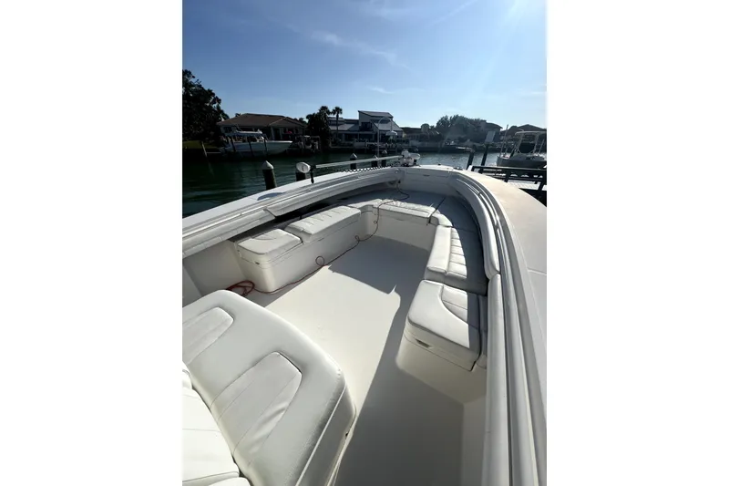 Slide: The Image of 2018 Regulator 34 Center Console boat cruising on clear water with lush greenery background. - 3