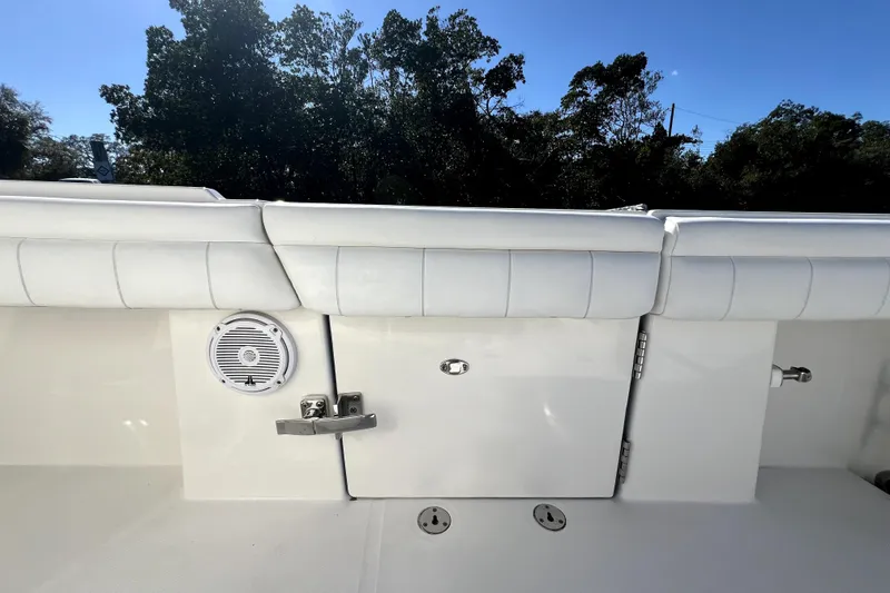 Slide: The Image of 2018 Regulator 34 Center Console boat interior with white seating and speaker. - 34