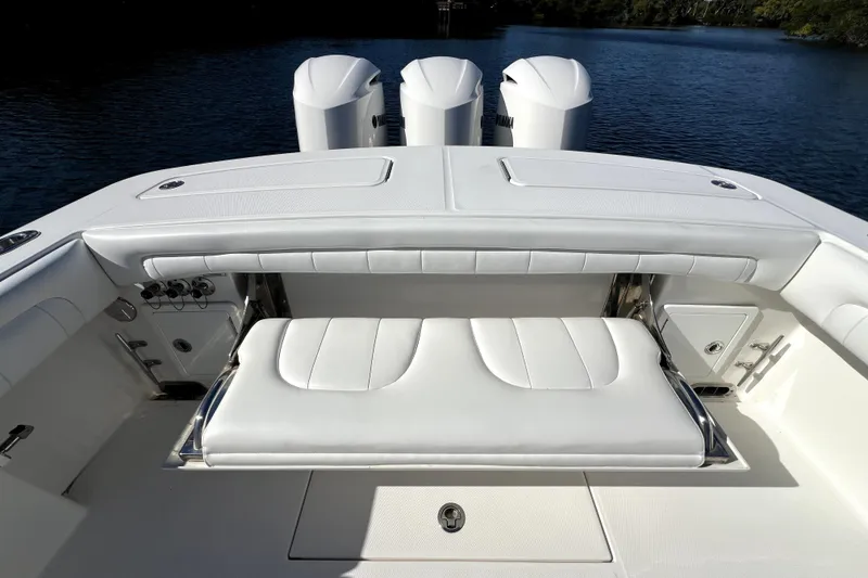 Slide: The Image of 2018 Regulator 34 Center Console boat interior with white seating and triple engines. - 38