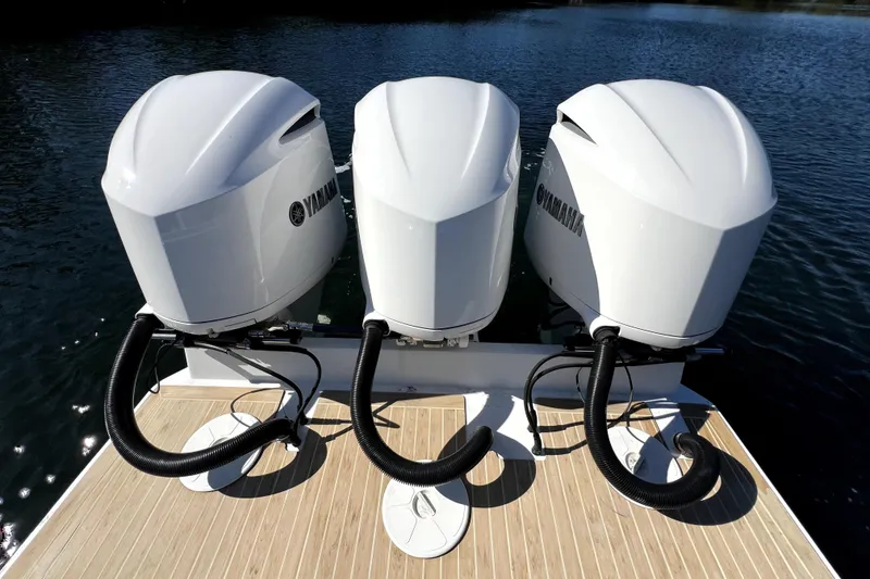 Slide: The Image of Triple Yamaha outboard engines on a 2018 Regulator 34 Center Console boat. - 44