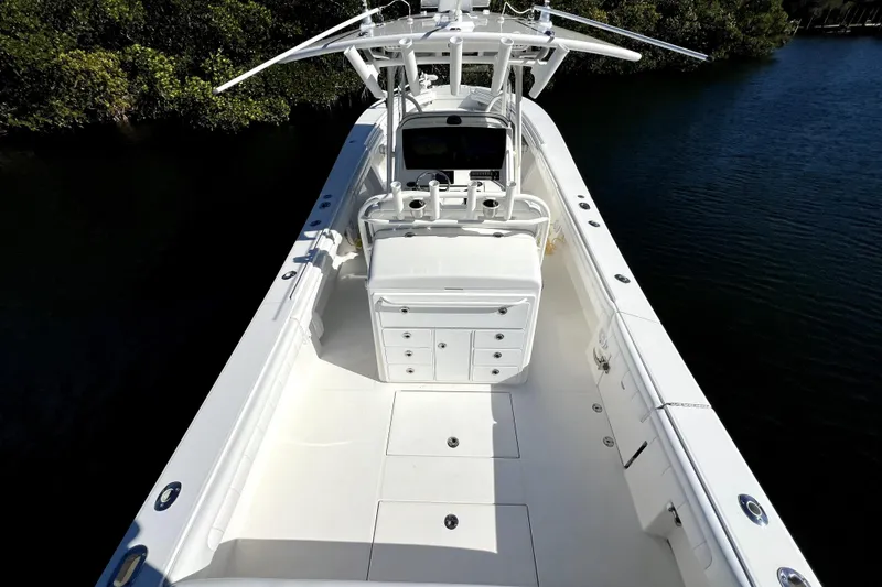 Slide: The Image of 2018 Regulator 34 Center Console boat on calm water, showcasing spacious deck and helm. - 47