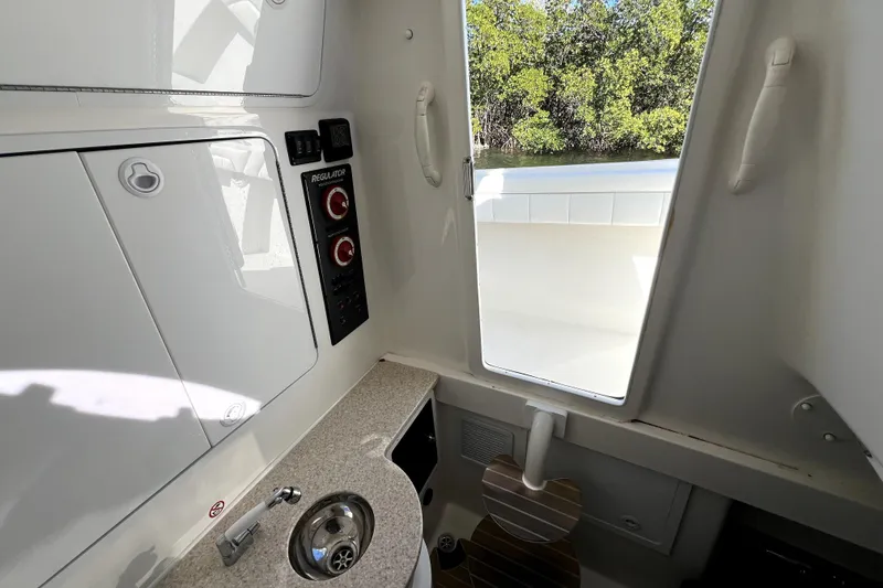 Slide: The Image of Interior of 2018 Regulator 34 Center Console boat with sink and control panel. - 55