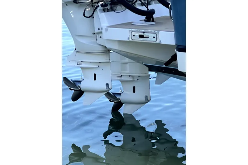 Slide: The Image of 2018 Regulator 34 Center Console boat with dual outboard motors on water. - 59