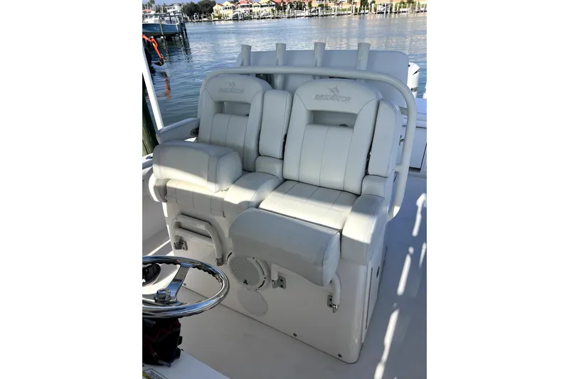 Slide: The Image of 2018 Regulator 34 Center Console boat with Yamaha engines cruising in a scenic waterway. - 6