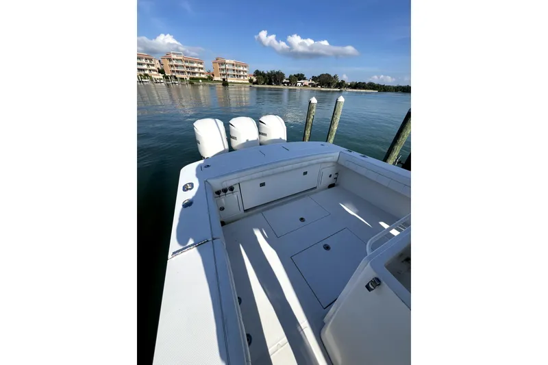 Slide: The Image of 2018 Regulator 34 Center Console boat with triple 300 horsepower engines in a scenic waterway. - 7