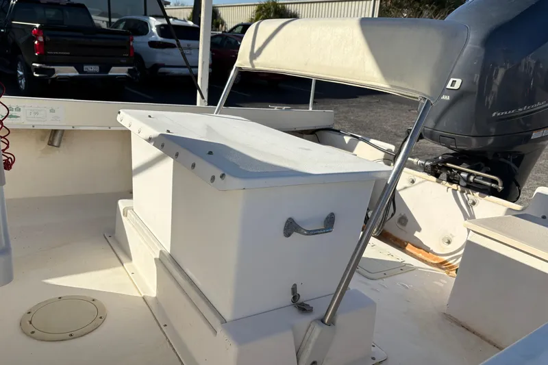 Slide: The Image of 1992 Parker 18 boat interior with seating and Yamaha outboard motor. - 11