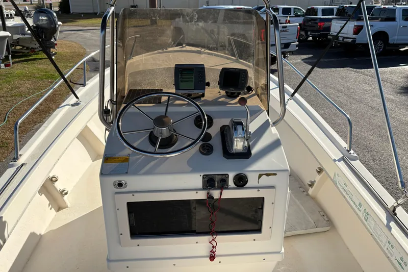 Slide: The Image of 1992 Parker 18 boat dashboard with steering wheel and navigation equipment. - 12