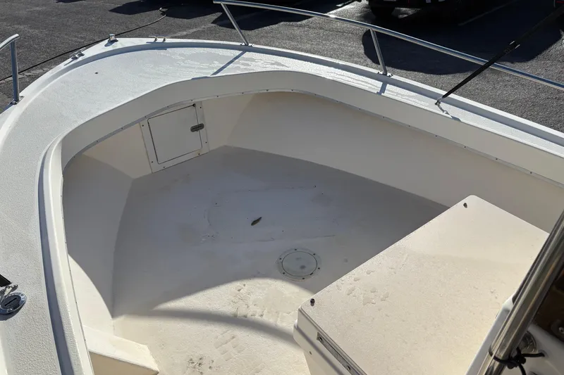Slide: The Image of 1992 Parker 18 boat interior with storage compartment and seating area. - 14