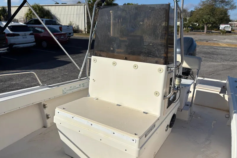Slide: The Image of 1992 Parker 18 boat console with seating, parked outdoors in a lot. - 15